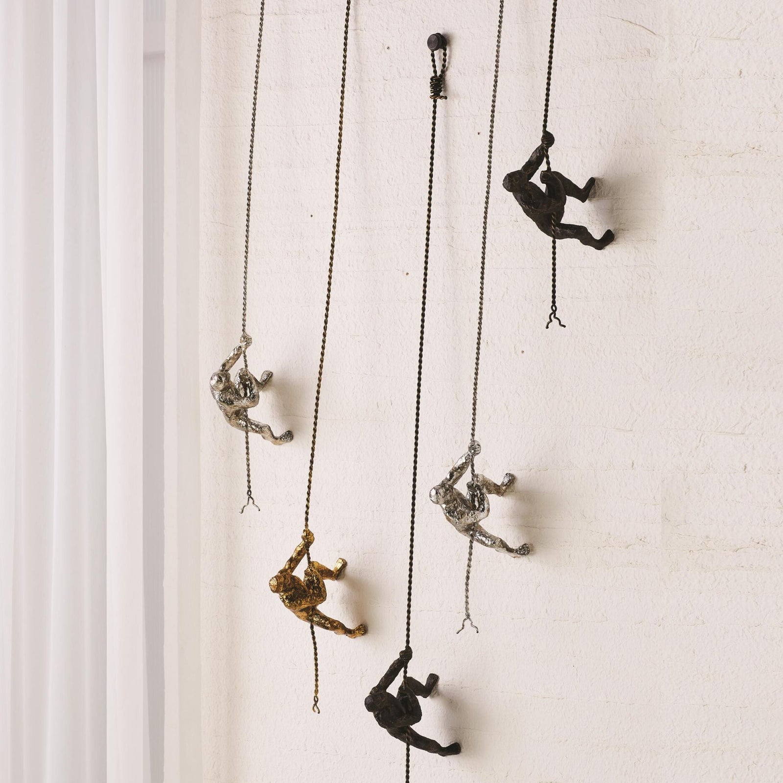 Global Views Climbing Man Wall Sculpture Bronze – room setting