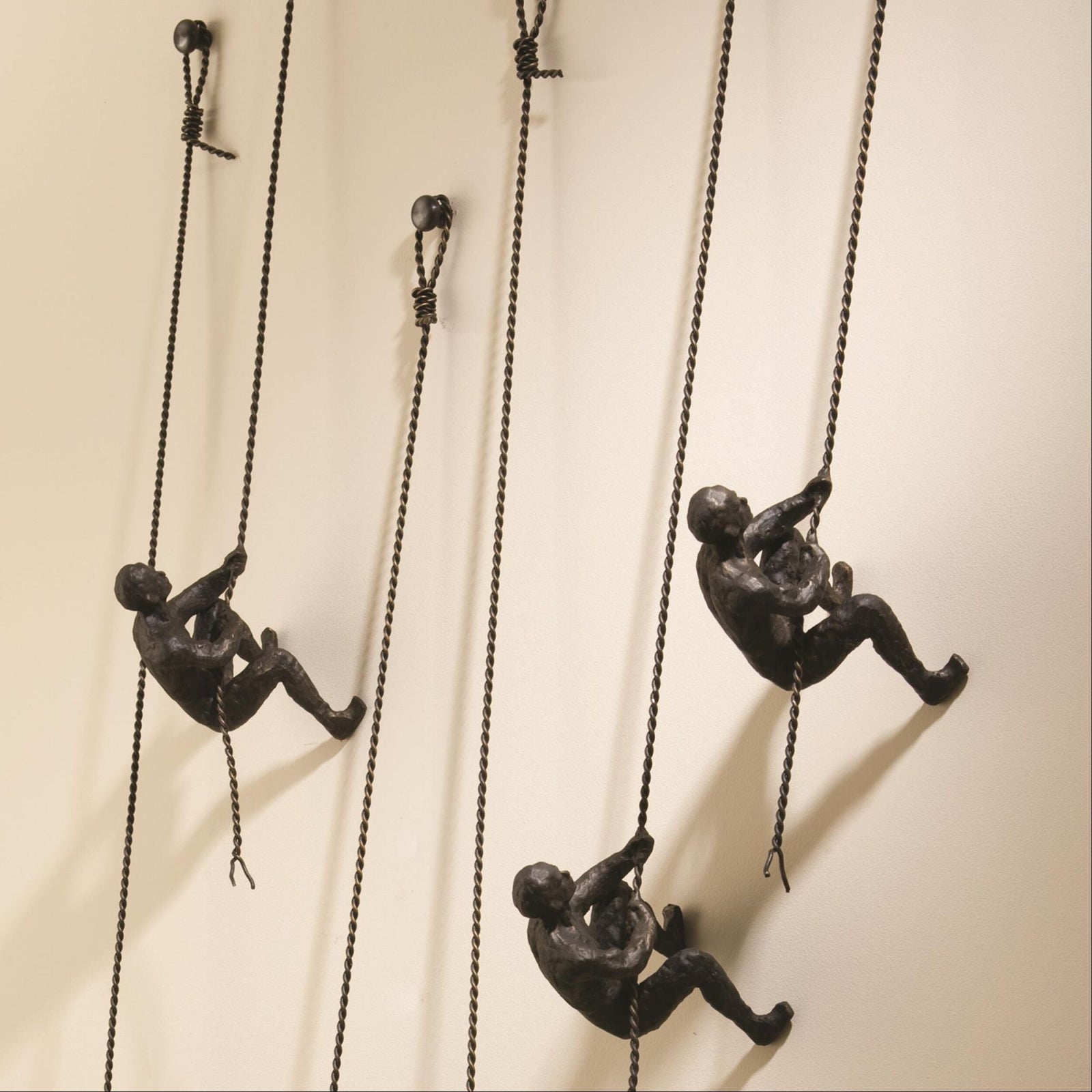 Global Views Climbing Man Wall Sculpture Bronze – room setting