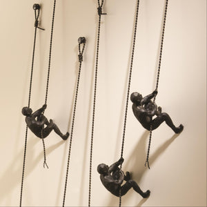 Global Views Climbing Man Wall Sculpture Bronze – room setting